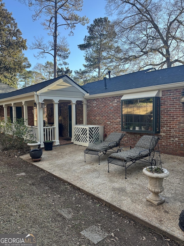 exterior space featuring covered porch and a patio