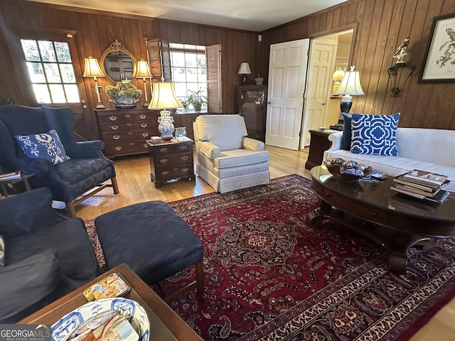 living room featuring wooden walls and light wood-type flooring