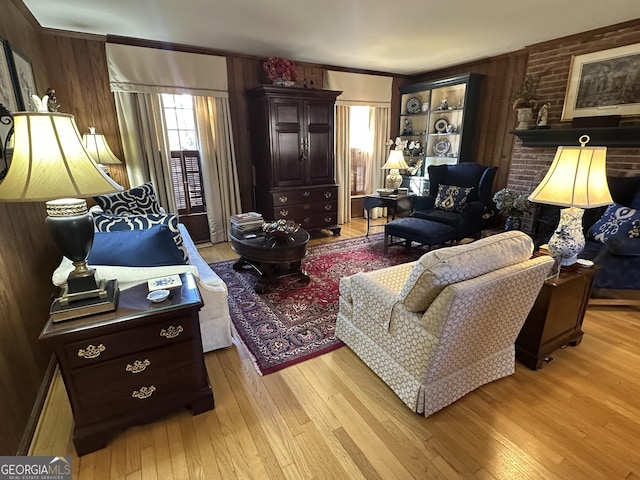 living room featuring light wood-type flooring and wood walls