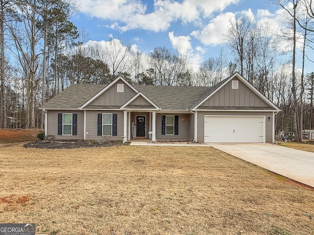 view of front of property with a front yard and a garage