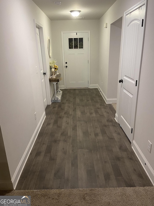 hallway with dark hardwood / wood-style flooring