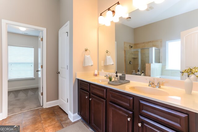 bathroom featuring a shower with door, vanity, and a wealth of natural light