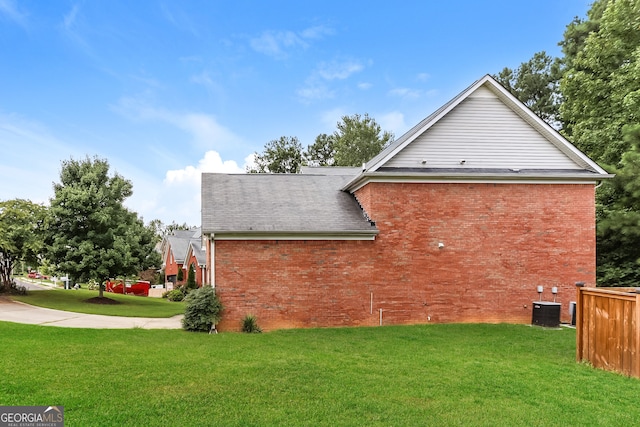 view of side of property featuring a yard and cooling unit