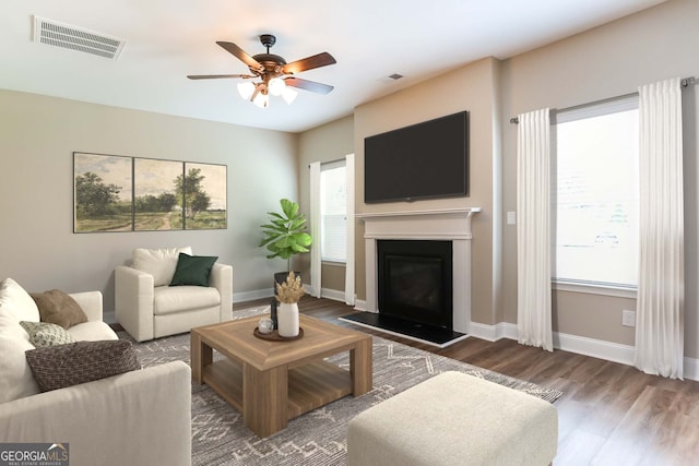 living room with ceiling fan and dark hardwood / wood-style flooring