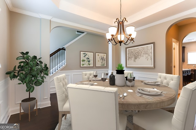 dining space with a notable chandelier, dark wood-type flooring, ornamental molding, and a raised ceiling