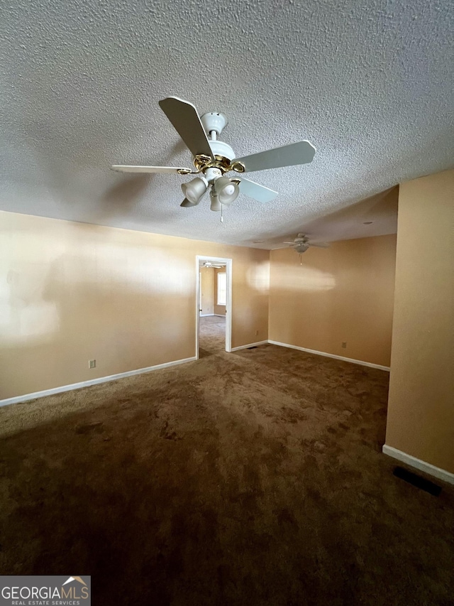 unfurnished room with a textured ceiling, ceiling fan, and carpet