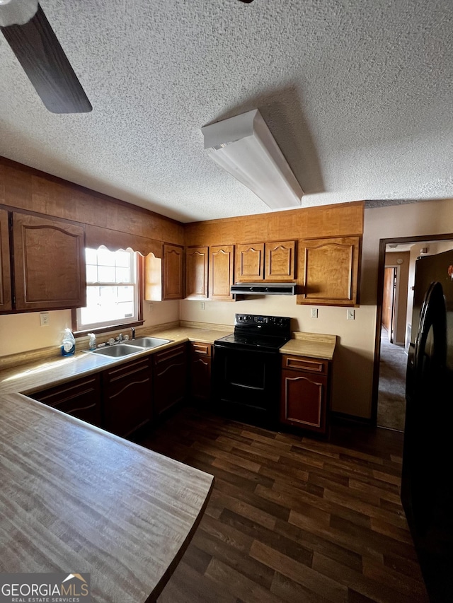 kitchen featuring sink, a textured ceiling, ceiling fan, dark hardwood / wood-style flooring, and black appliances