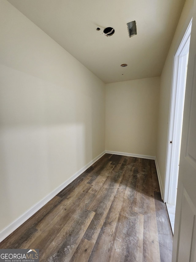 spare room featuring wood-type flooring