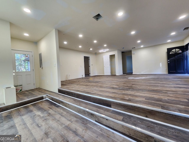 interior space with dark wood-type flooring and electric panel