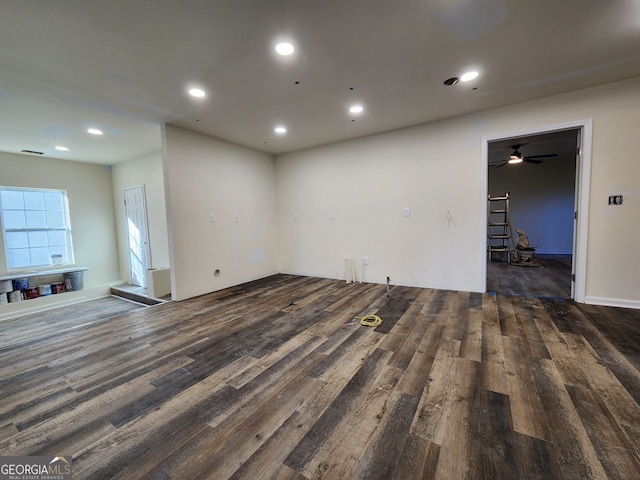 unfurnished living room featuring dark wood-type flooring