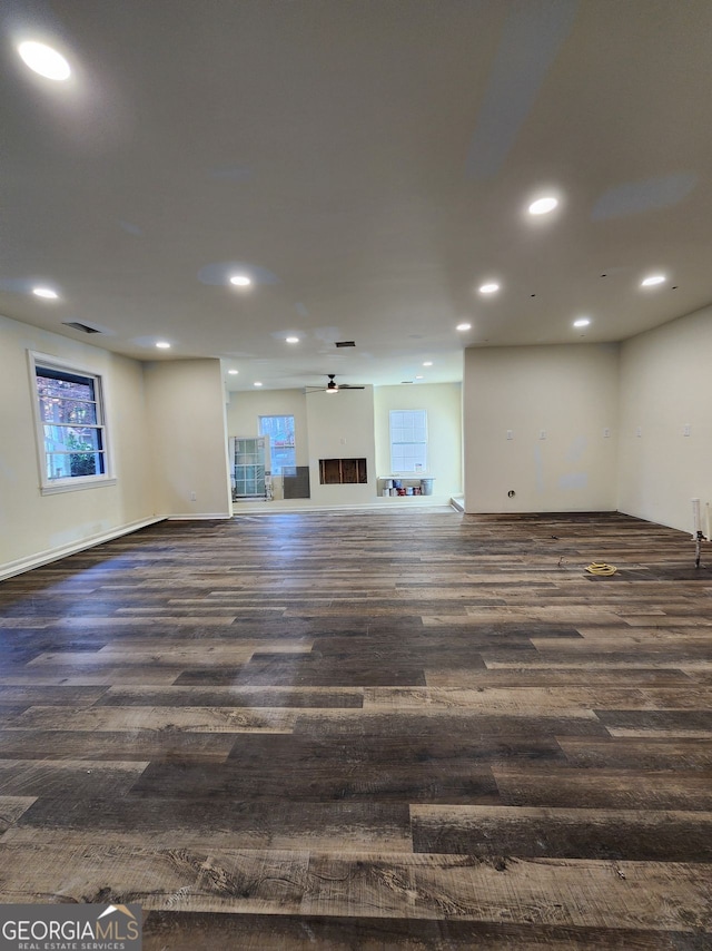 basement featuring dark wood-type flooring and ceiling fan