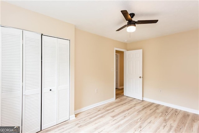 unfurnished bedroom featuring ceiling fan, light hardwood / wood-style flooring, and a closet