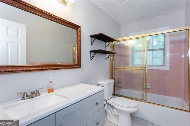 full bathroom with toilet, vanity, a textured ceiling, and combined bath / shower with glass door