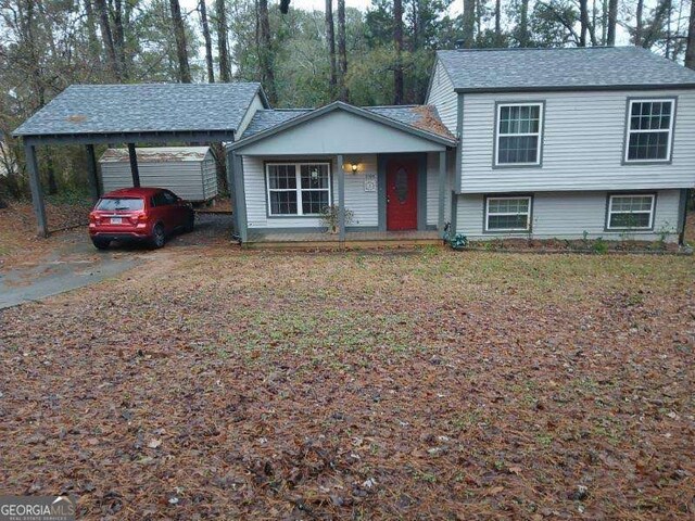 split level home with a porch and a carport