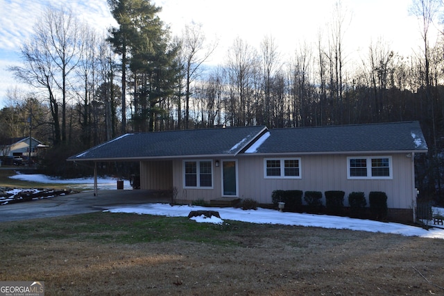 ranch-style house featuring a carport