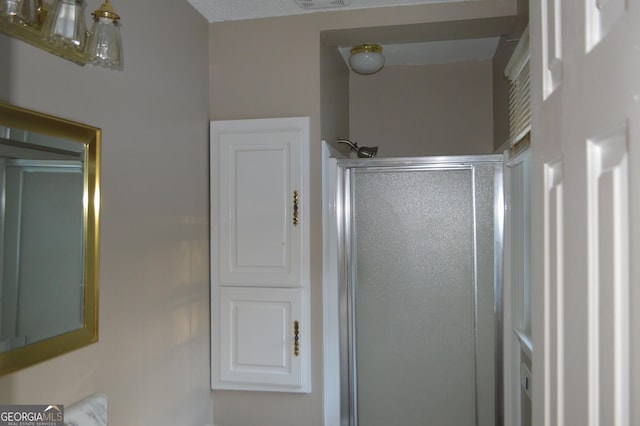 full bathroom with a shower stall and visible vents