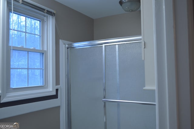 bathroom featuring a shower with door