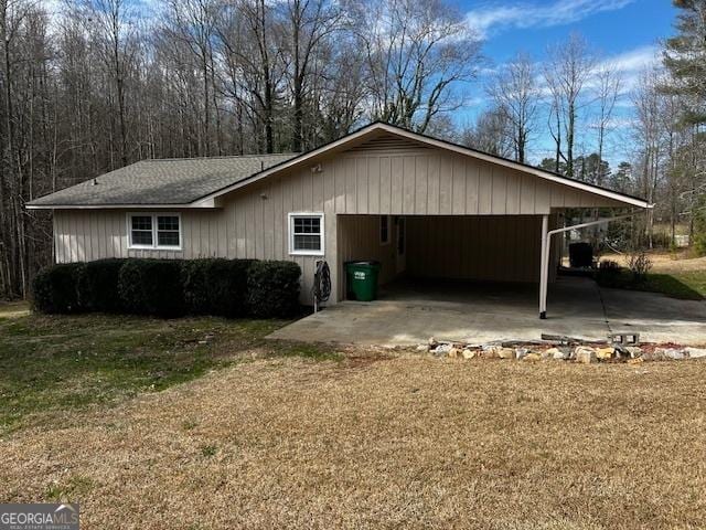 view of property exterior featuring a garage, driveway, and a lawn