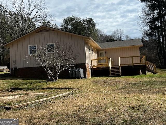 exterior space featuring a deck and a yard