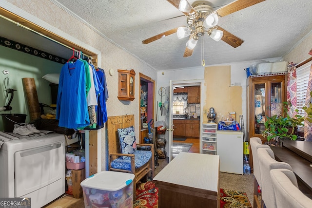 interior space featuring multiple windows, washer / clothes dryer, a textured ceiling, and ceiling fan