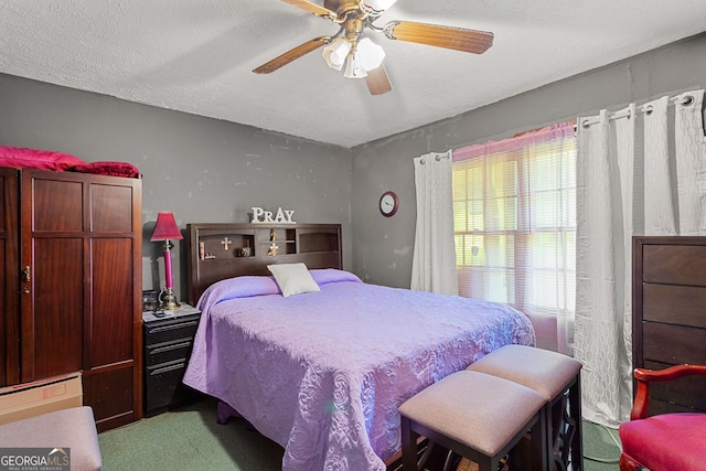 bedroom featuring carpet flooring, a textured ceiling, and ceiling fan