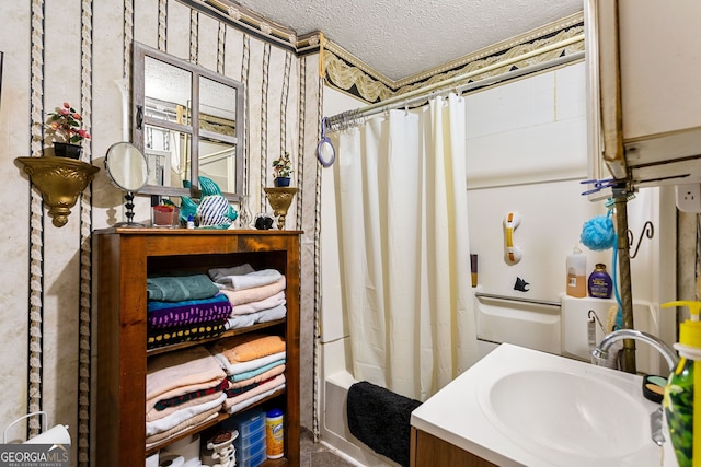 bathroom featuring vanity, a textured ceiling, and shower / bath combo with shower curtain