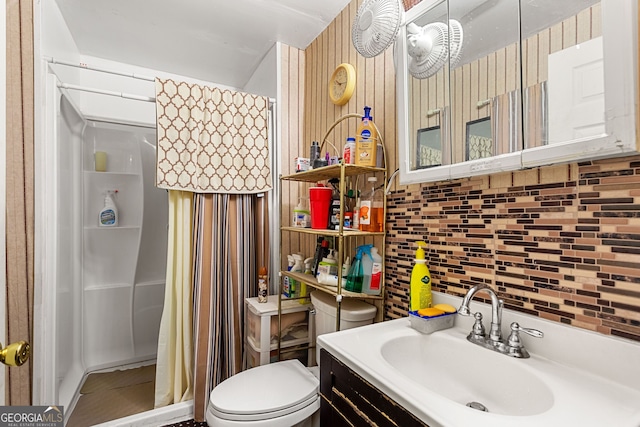 bathroom featuring vanity, curtained shower, decorative backsplash, and toilet