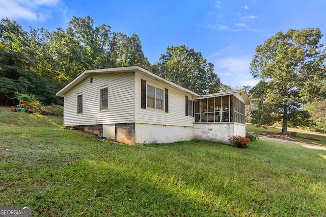 exterior space featuring a front lawn and a sunroom