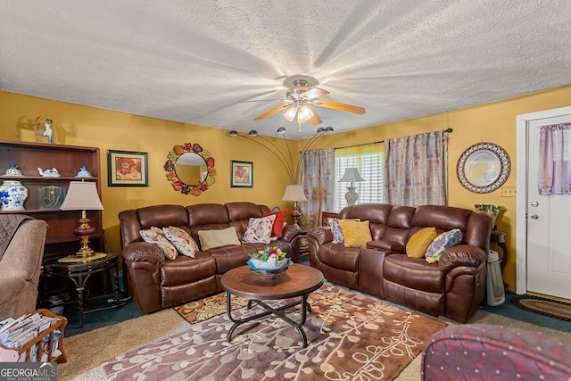 carpeted living room with ceiling fan and a textured ceiling