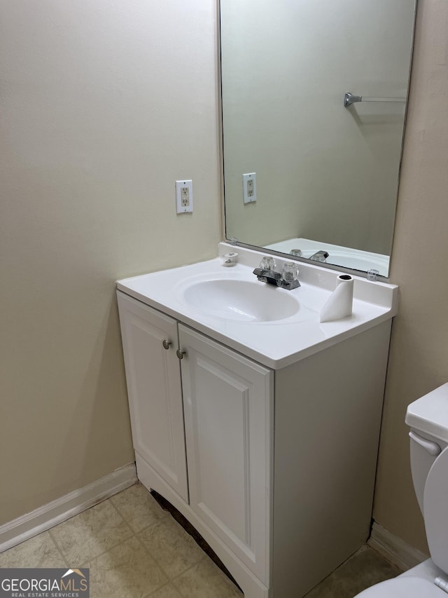 bathroom featuring toilet and vanity