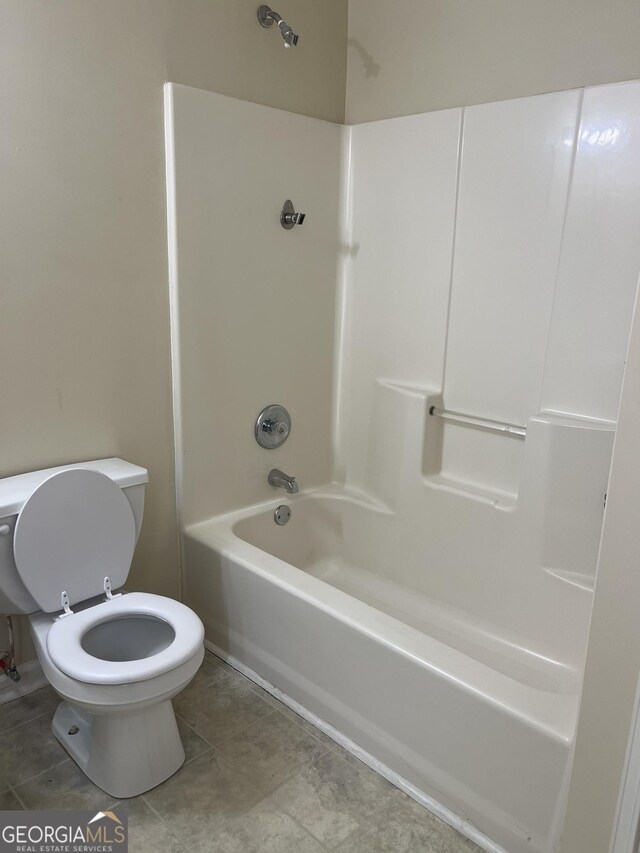 bathroom with shower / tub combination and toilet