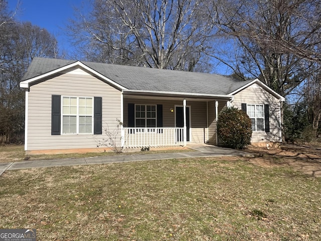 ranch-style home with a front yard and covered porch