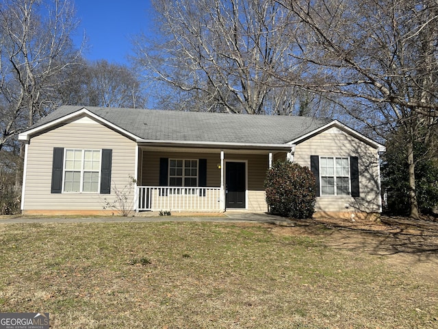 ranch-style home featuring covered porch and a front lawn