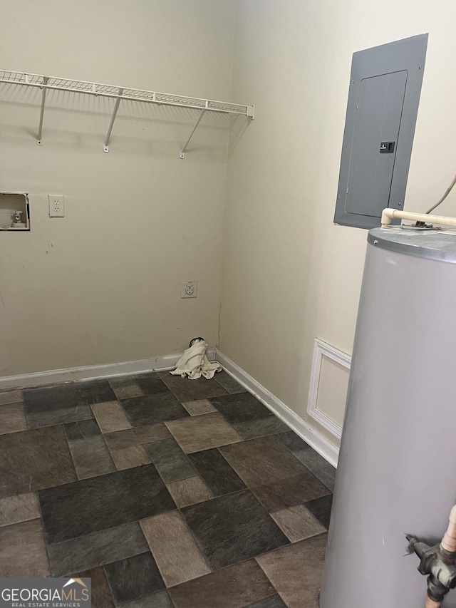 clothes washing area featuring electric panel, water heater, and washer hookup