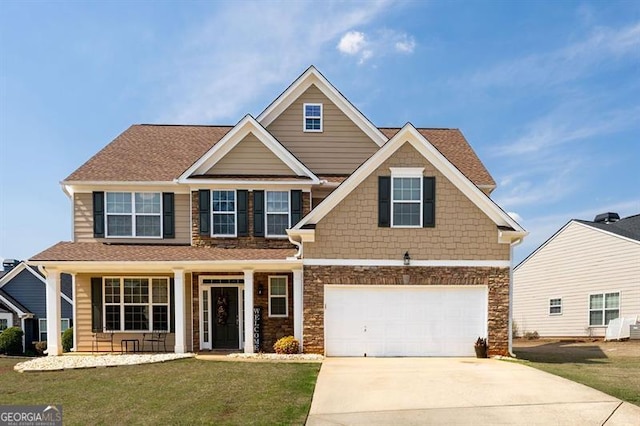 craftsman-style house featuring a front lawn and a garage