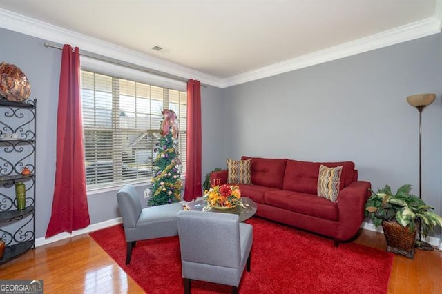 living room featuring wood-type flooring and ornamental molding