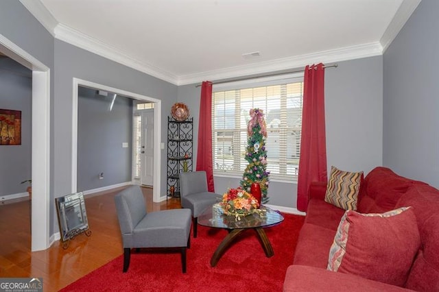 living area featuring wood-type flooring and ornamental molding