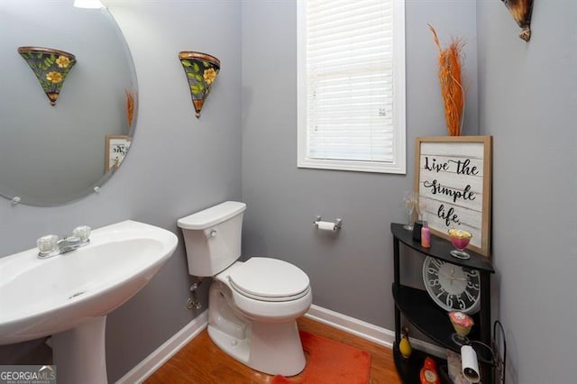 bathroom featuring sink, hardwood / wood-style floors, and toilet