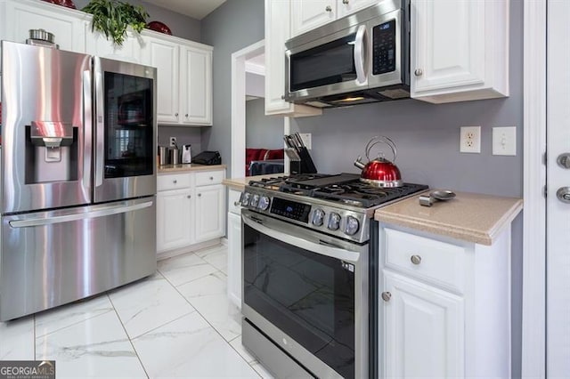 kitchen with stainless steel appliances and white cabinetry