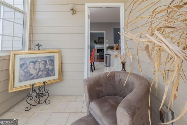 sitting room with plenty of natural light and light tile patterned floors