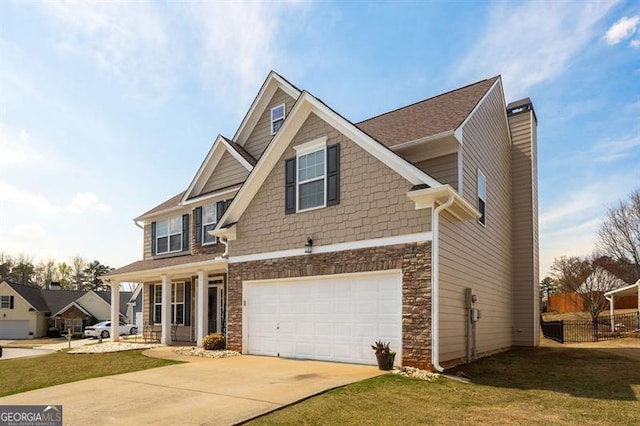 craftsman-style home with a front yard, a garage, and covered porch