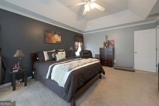 bedroom with ceiling fan, a tray ceiling, ornamental molding, and light colored carpet