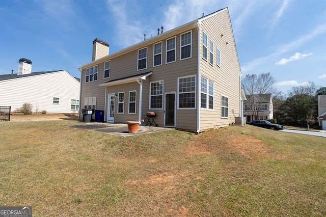 back of house featuring a patio and a yard