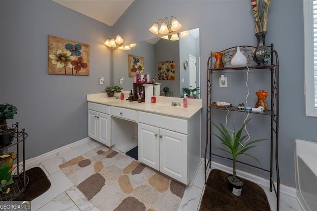 bathroom with lofted ceiling and vanity