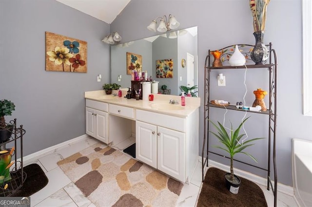 bathroom featuring vaulted ceiling and vanity