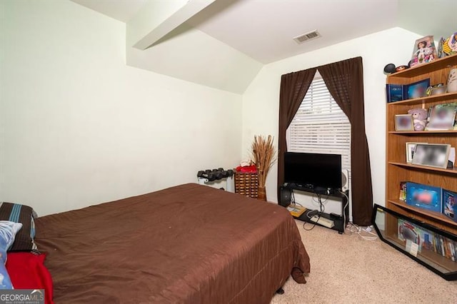 bedroom with vaulted ceiling and light colored carpet