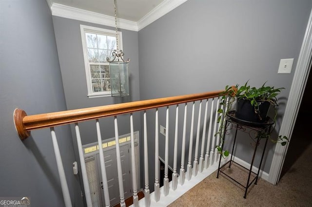 interior space with a notable chandelier, carpet, and crown molding