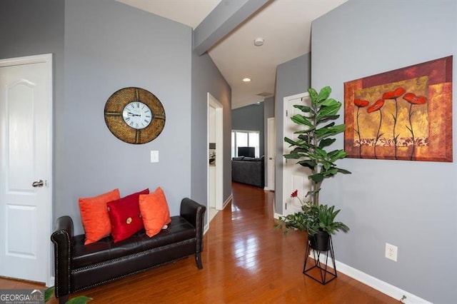 corridor with lofted ceiling with beams and hardwood / wood-style flooring