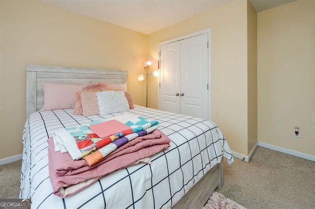 bedroom featuring a closet and light colored carpet