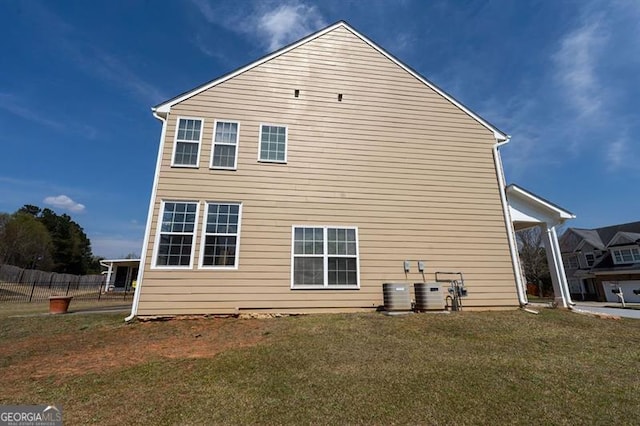 view of property exterior featuring a lawn and central AC unit